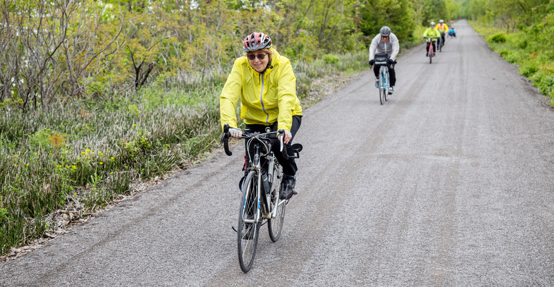 group of cyclists riding on stone dusted trail