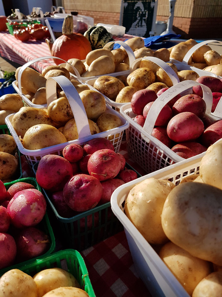 baskets of potatoes at market