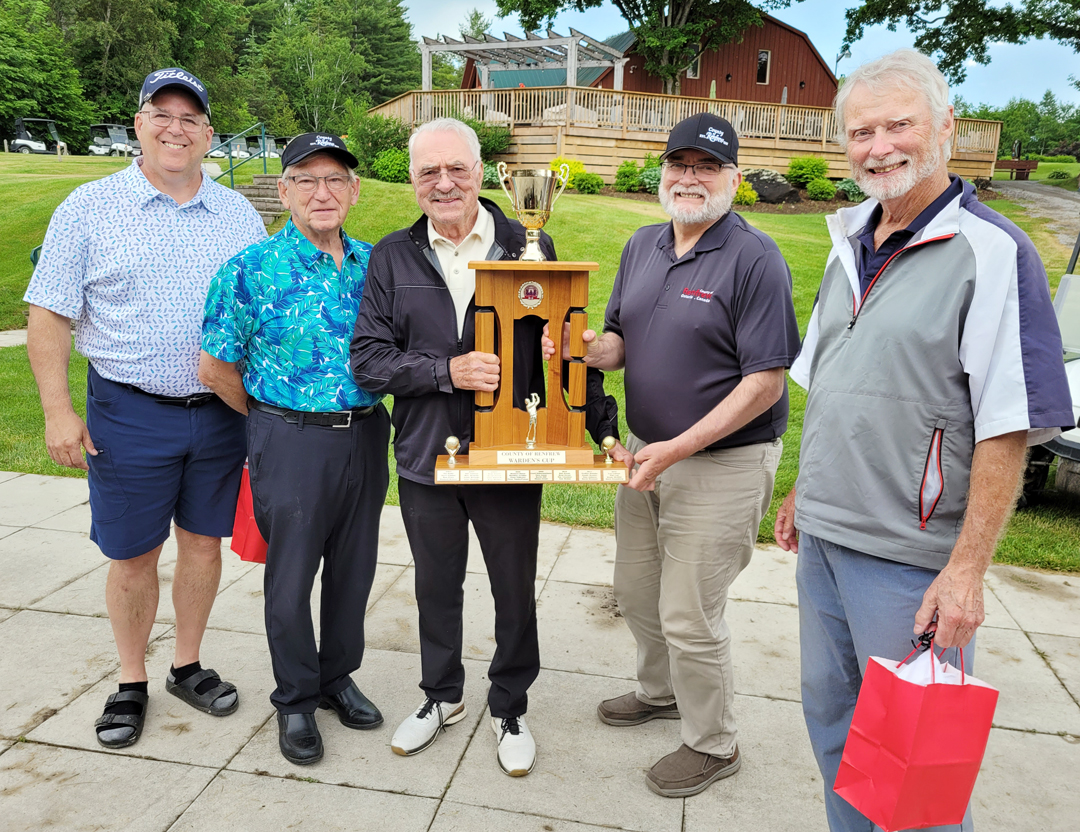 winning golf team with trophy and warden