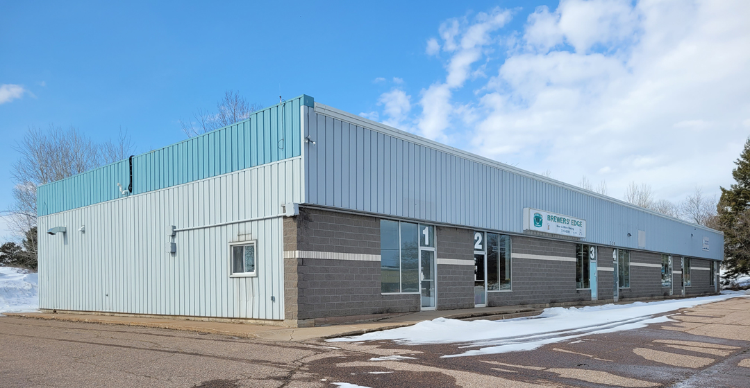 Photo of industrial type building, with blue sky background